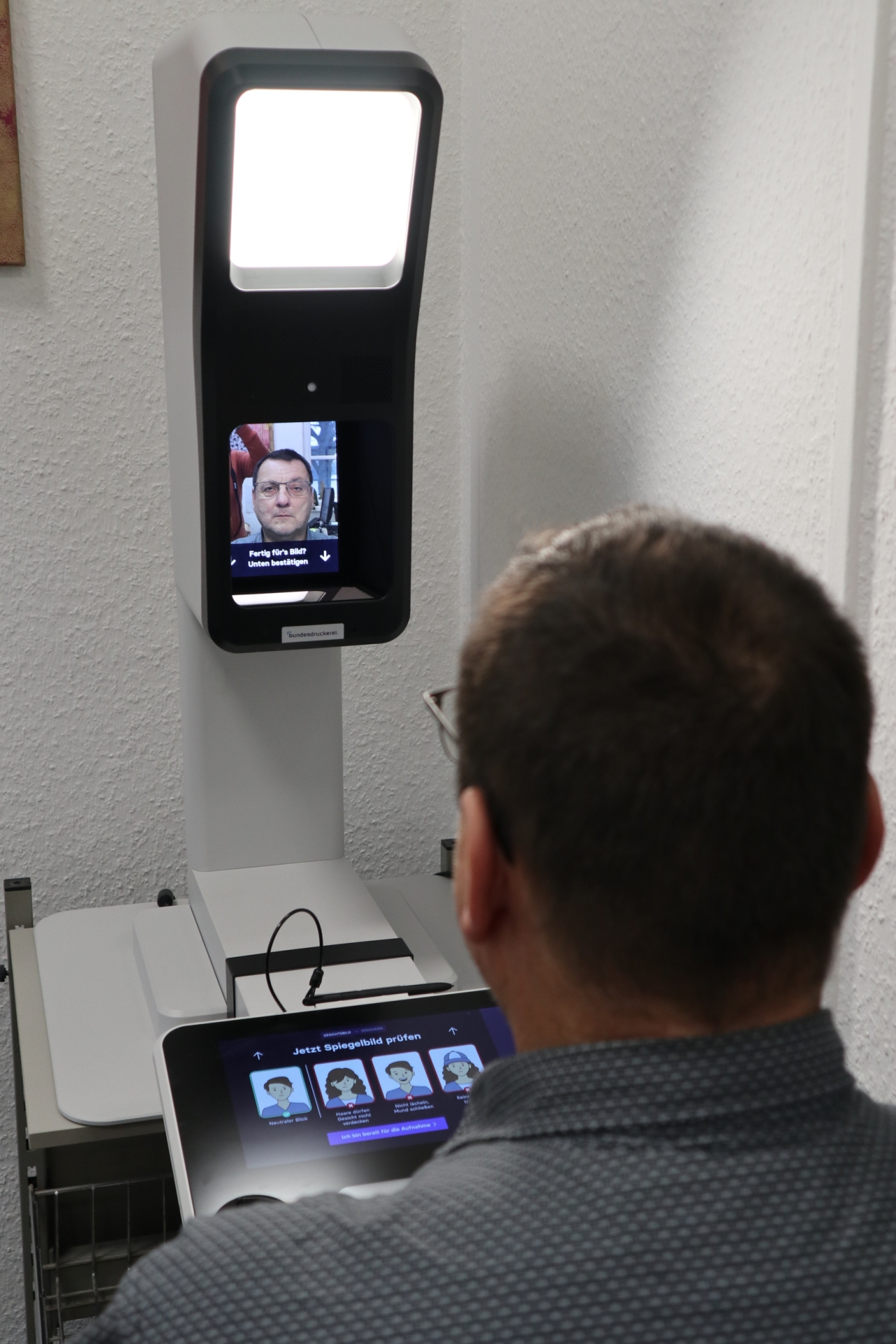 Das Foto zeigt die Anwendung der neuen Passbildkamera im Sinziger Rathaus