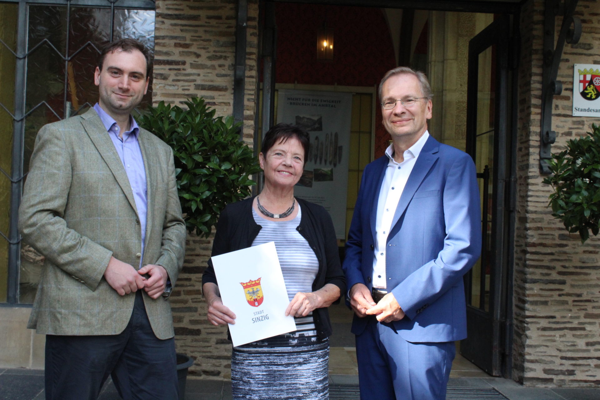 Das Foto zeigt Museumsleiterin Agnes Menacher, die von Bürgermeister Andreas Geron (r.) in den Ruhestand verabschiedet wurde. Ihr Nachfolger Gabriel Heeren (l.) wurde als neuer Museumsleiter im Schloss begrüßt.